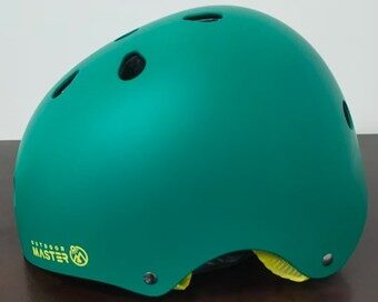 Teal bicycle helmet with black vents and yellow lining on a dark surface.
