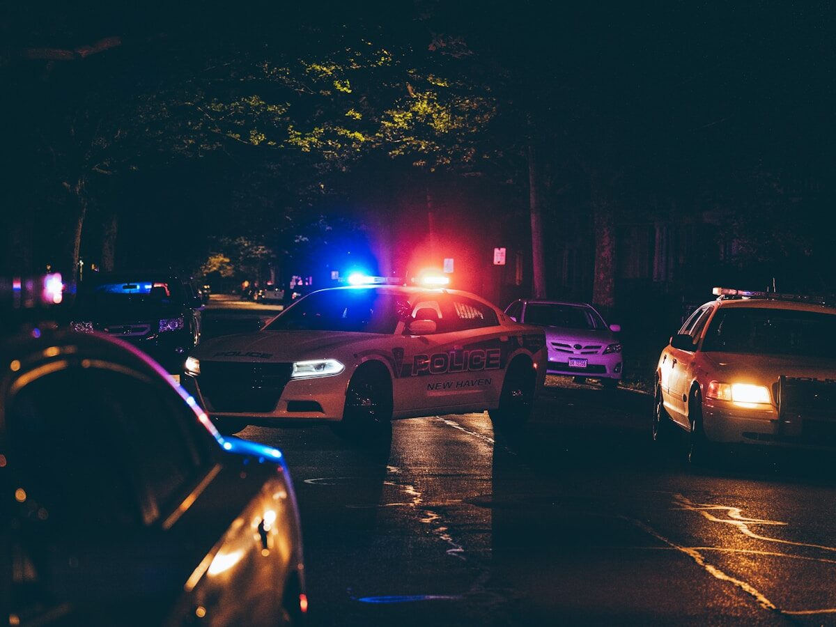 A couple of police cars parked in a parking lot