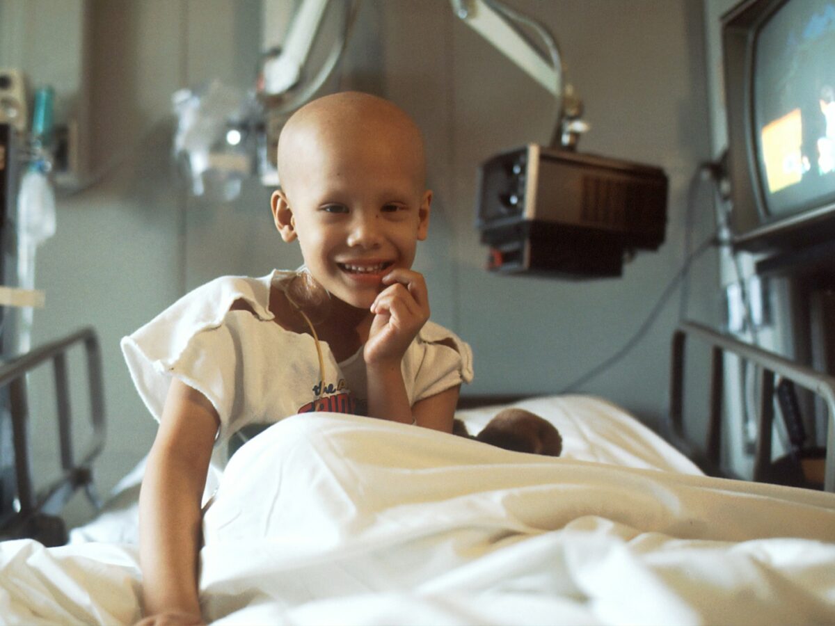 child sitting on bed