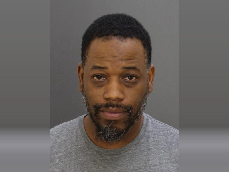 Portrait of a man facing forward against a plain gray background.