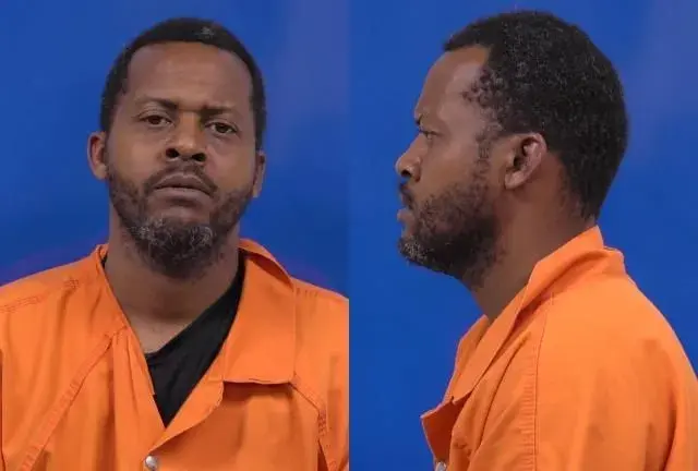 Mugshot-style portrait of a man in an orange jumpsuit shown front and profile against a blue background.