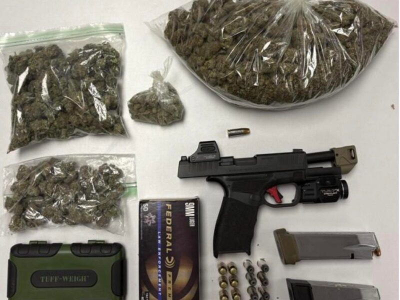 Bagged cannabis, handgun, ammunition, and magazines laid out on a white surface.