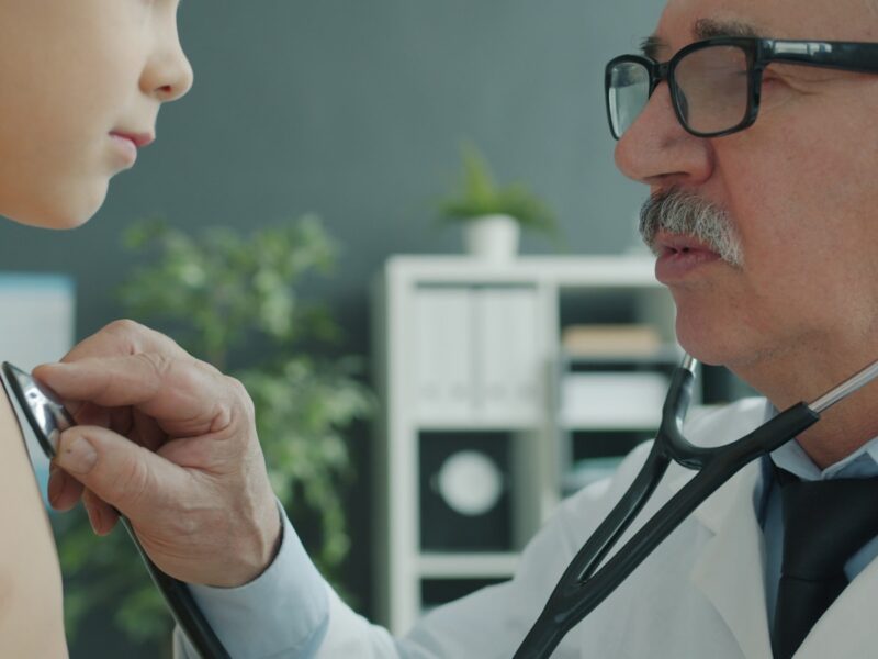 Doctor examines child's chest with stethoscope