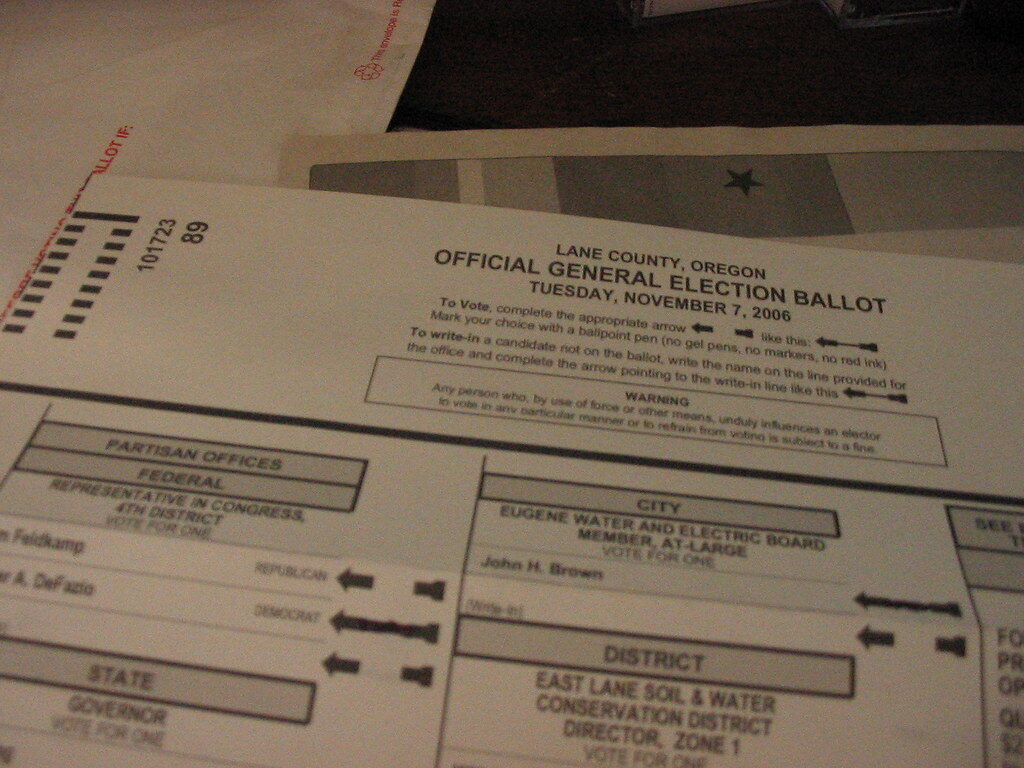Stack of official general election ballots laid out on a table.