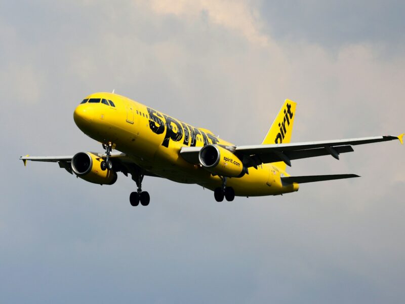 a yellow and black airplane flying