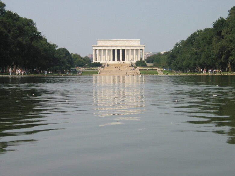 Lincoln Memorial across the Reflecting Pool with trees framing the Washington, D.C. landmark