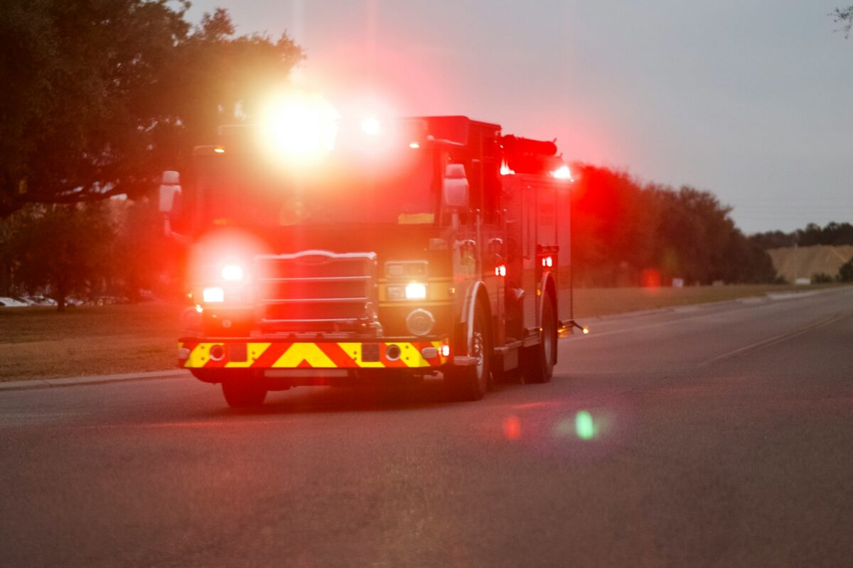 red and white fire truck on road during night time