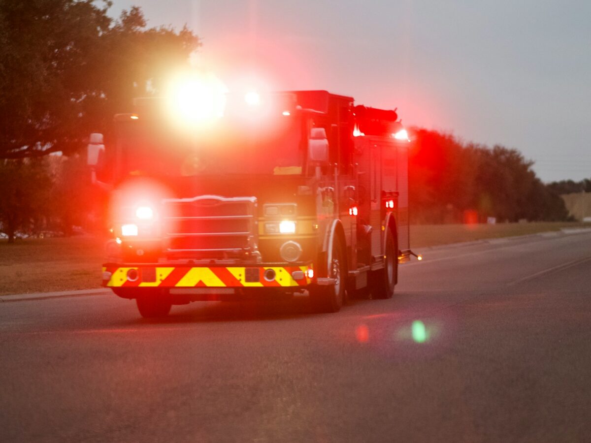 red and white fire truck on road during night time