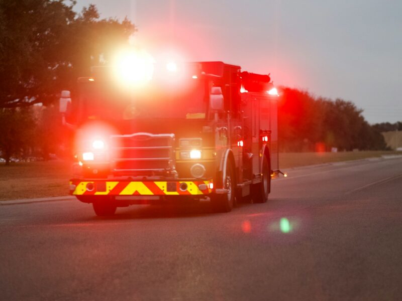 red and white fire truck on road during night time