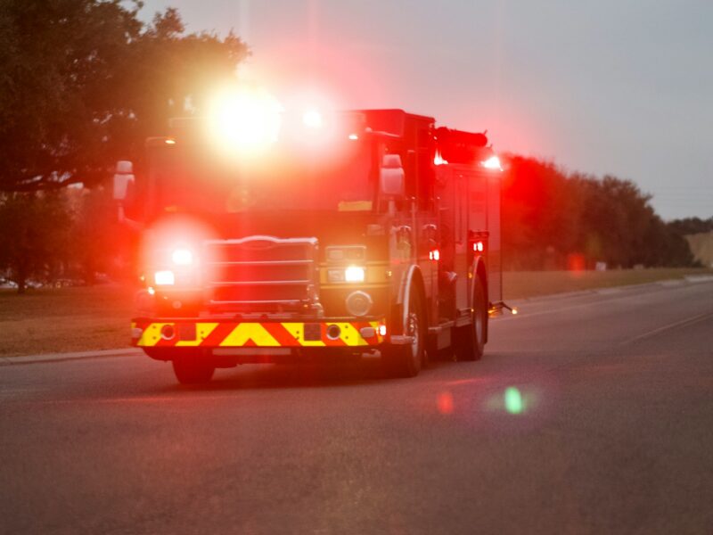 red and white fire truck on road during night time