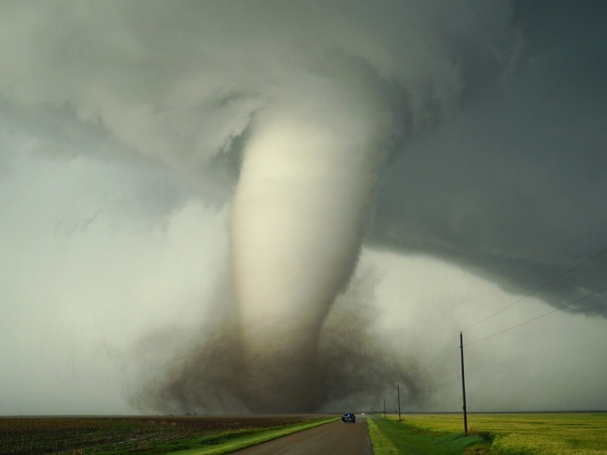 a large tornado is coming down the road
