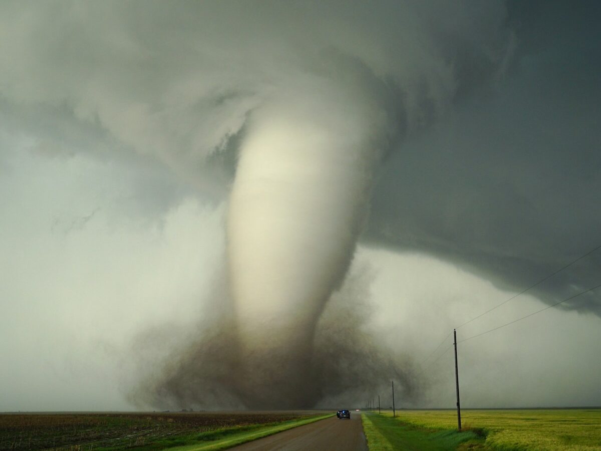 a large tornado is coming down the road