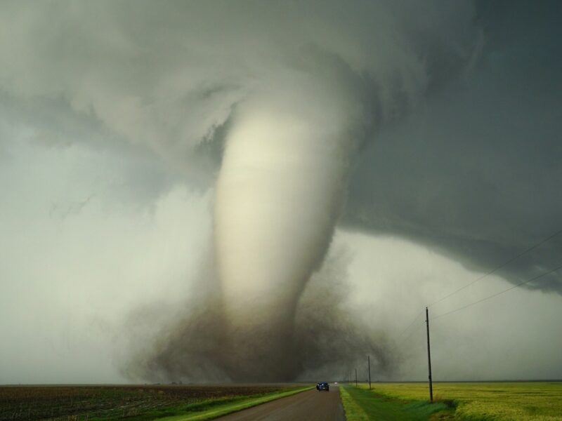 a large tornado is coming down the road