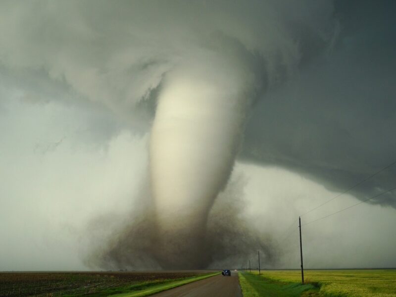 a large tornado is coming down the road